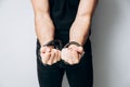 Male hands tied by a metal chain. Day of the struggle for the abolition of slavery. Royalty Free Stock Photo