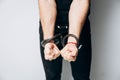 Male hands tied by a metal chain. Day of the struggle for the abolition of slavery. Royalty Free Stock Photo