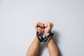 Male hands tied by a metal chain. Day of the struggle for the abolition of slavery. Royalty Free Stock Photo