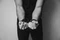 Male hands tied by a metal chain. Day of the struggle for the abolition of slavery. Royalty Free Stock Photo