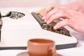 Male hands type story or report using white vintage typewriter equipment close up. Writing routine. Vintage typewriter Royalty Free Stock Photo