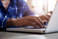 Male hands typing on laptop computer