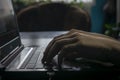 Male hands on a laptop keyboard