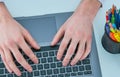 Male hands typing on laptop keyboard. Young man using laptop computer. Business working concept. Royalty Free Stock Photo