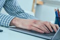 Male hands typing on laptop keyboard. Young man using laptop computer. Business working concept. Royalty Free Stock Photo