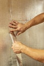 Male hands using aluminum tape to glue the joint foil insulation