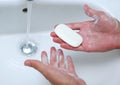 Male hands washing with soap water