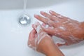 Male hands washing with soap water