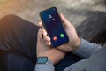 Male hands with watch holding phone with incoming call