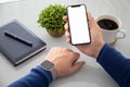 Male hands holding phone with isolated screen table in the office Royalty Free Stock Photo