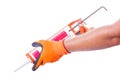 Male hands work gloves hold sealant gun