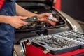 Male hands with wrench and car part