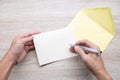 Hands writing Empty cards on wooden table