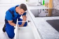 Male Handyman Installing Drawer