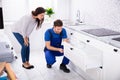 Male Handyman Installing Drawer