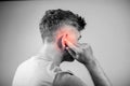 Male having ear pain touching his painful head isolated on gray Royalty Free Stock Photo