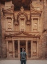 Male in a headscarf standing in front of the historic Petra Wadi in Jordan