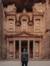 Male in a headscarf standing in front of the historic Petra Wadi in Jordan