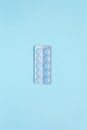 Male health. Blister with round blue pills on light blue background. Taking medicine. Start treatment for disease. Royalty Free Stock Photo