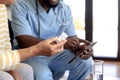 Male health worker with digital tablet discussing with caucasian senior woman over medication dose