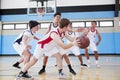 Male High School Basketball Team Dribbling Ball On Court