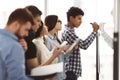 Male high school pupil writing on whiteboard in class Royalty Free Stock Photo