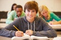 Male High School Student Studying At Desk In Classroom Royalty Free Stock Photo