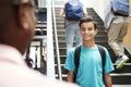Male High School Student Talking With Teacher In Busy Corridor Royalty Free Stock Photo