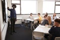 Male High School Teacher Standing Next To Interactive Whiteboard And Teaching Lesson Royalty Free Stock Photo