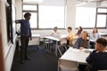Male High School Teacher Standing Next To Interactive Whiteboard And Teaching Lesson Royalty Free Stock Photo