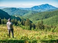 Male hiker admiring the beautiful landscape in the Carpathian Mountains, Romania