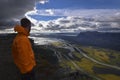 Male hiker enjoying the view over rapadalen river delta in rainy landscape