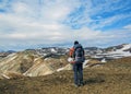 Male hiker hiking alone into the wild admiring volcanic landscape with heavy backpack. Travel lifestyle adventure wanderlust Royalty Free Stock Photo