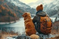 Male hiker and his pet dog admiring a scenic view from a mountain top. Adventurous young man with a backpack. Hiking and trekking