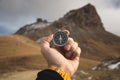 A male Hiker is looking for a direction with a magnetic compass in the mountains in the fall. Point of view shot. Man`s Royalty Free Stock Photo