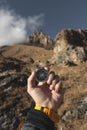 A male Hiker is looking for a direction with a magnetic compass in the mountains in the fall. Point of view shot. Man`s Royalty Free Stock Photo