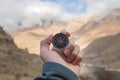 A male Hiker is looking for a direction with a magnetic compass in the mountains in the fall. Point of view shot. Man`s Royalty Free Stock Photo