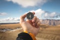 A male Hiker is looking for a direction with a magnetic compass in the mountains in the fall. Point of view shot. Man`s Royalty Free Stock Photo