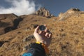 A male Hiker is looking for a direction with a magnetic compass in the mountains in the fall. Point of view shot. Man`s Royalty Free Stock Photo