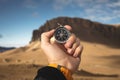 A male Hiker is looking for a direction with a magnetic compass in the mountains in the fall. Point of view shot. Man`s Royalty Free Stock Photo