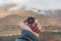 A male Hiker is looking for a direction with a magnetic compass in the mountains in the fall. Point of view shot. Man`s Royalty Free Stock Photo