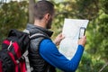 Male hiker looking at map and mobile phone Royalty Free Stock Photo