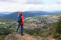 Male hiker (man) standing on mountain Silberberg and looking at panorama of municipality Bodenmais in Bavarian Forest Royalty Free Stock Photo