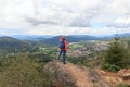 Male hiker (man) standing on mountain Silberberg and looking at panorama of Bodenmais in Bavarian Forest