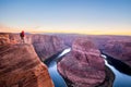 Male hiker overlooking Horseshoe Bend at sunset, Arizona, USA Royalty Free Stock Photo