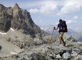 Male hiker on a rocky and dusty hiking trail in the French Alps Royalty Free Stock Photo