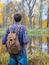 Male hiker stand near autumn lake