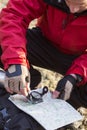 Male hiker using compass and map in forest Royalty Free Stock Photo