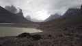 Male hiker with very big and heavy backpack walking around summit lake in the remote arctic wilderness of Baffin Island