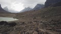 Male hiker with very big and heavy backpack walking around summit lake in the remote arctic wilderness of Baffin Island